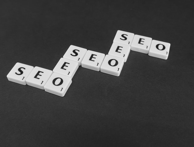 Tiles of letter blocks spelling out “SEO” multiple times and arranged like dominos.